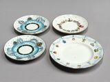 three plates with designs on them are sitting on a table