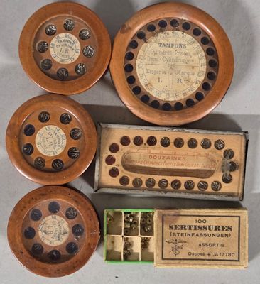 four wooden clocks and a box of matchesticks on a table