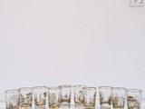 several shot glasses are lined up in a row on a marble surface