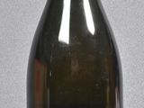 a bottle with a label on it sitting on a table