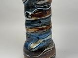 a small vase that has a blue and brown design on it