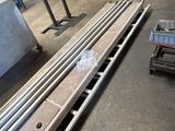several pieces of metal are stacked on pallets in a warehouse
