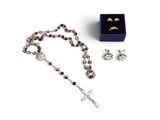 a rosary, ring, and earring set in a blue box
