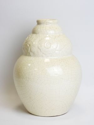 a white vase that is sitting on a white surface