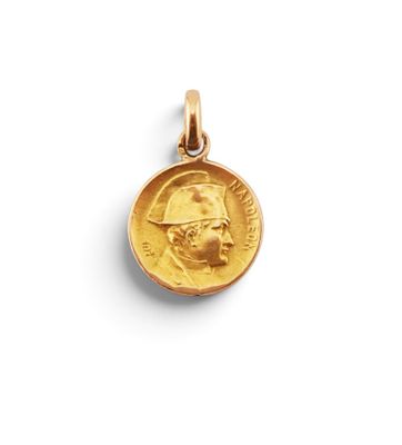 a close up of a gold coin with a man ' s face on it
