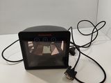 a small clock that is connected to a charger on the table