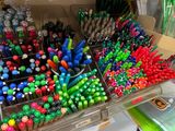 a lot of pens and pencils in a box