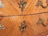 a chest of drawers that has a marble top on it