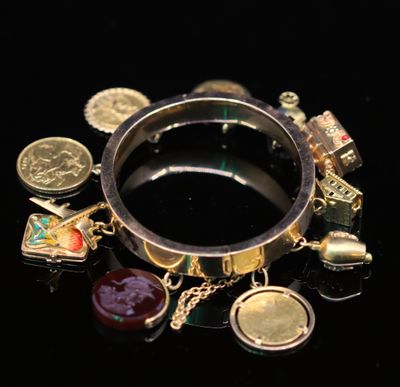 a ring with many charms on it on a black surface