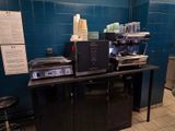 a coffee machine sitting on top of a counter in a coffee shop