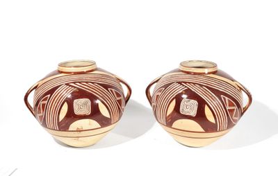 two brown vases sitting next to each other on a white surface