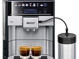 a close up of a coffee machine with two cups of coffee