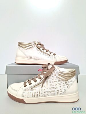 white sneakers with brown laces on them sitting on top of a box