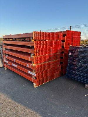 several stacks of steel bars stacked on top of each other in a parking lot