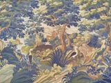 a tapestry with a picture of a forest scene on it