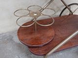 a wooden table with a metal holder on top of it