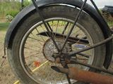 a motorcycle that is parked in the grass with a tire