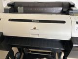 a canon printer sitting on a table in a room