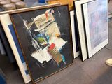 two framed art pieces on the floor next to each other