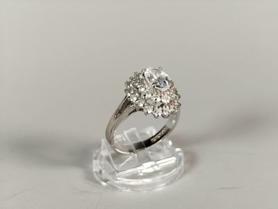 a diamond ring sitting on a clear stand