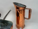 a copper pitcher and a copper pan on a white background