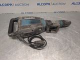 a close up of a drill on a table with a cord