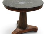 a black marble top table on a wooden pedestal