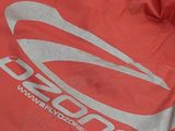 a red bag with a logo on it sitting on the ground