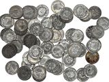 a close up of a pile of silver coins on a white surface