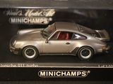 a silver model of a porsche 911 turbo car in a box