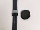 a smart watch sitting next to a smart watch on a table