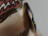 a close up picture of a vase with a bird on it