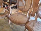 three wicker chairs are sitting in a room with a rug on the floor
