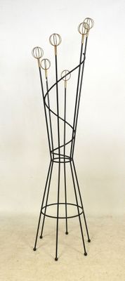 a coat rack with five pairs of scissors on it