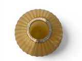 a yellow candle that is sitting on a white surface