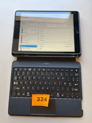 a tablet computer sitting next to a laptop computer on a table