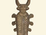 an image of a brass sculpture of a bug on a white background