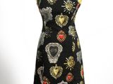 the dress is black with gold and red hearts on it
