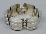bracelet made of silver plated metal on a white surface