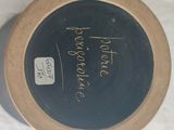 a black plate with writing on it sitting on a table