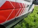 a red and white van parked on the side of the road