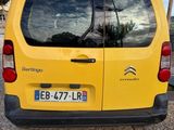 a small yellow van parked on the side of the road