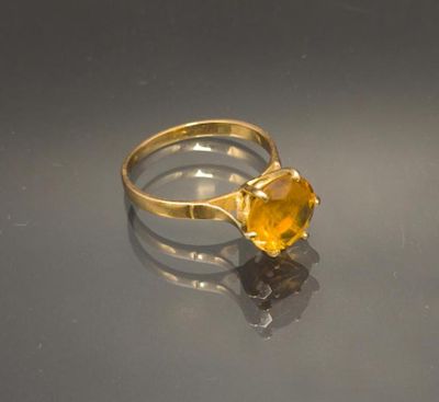 a gold ring with a citrine stone on it
