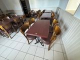 tables and chairs are lined up in a room with white tiles