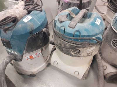 two vacuums that are sitting on top of a table