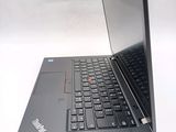 a laptop with a black keyboard on a white surface