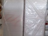 many rolls of plastic wrap on the floor in a warehouse