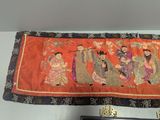 a picture of a wall hanging with a group of people on it