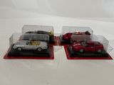 three model cars in a display case on a white surface