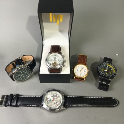 several different watches are sitting in a box on a table